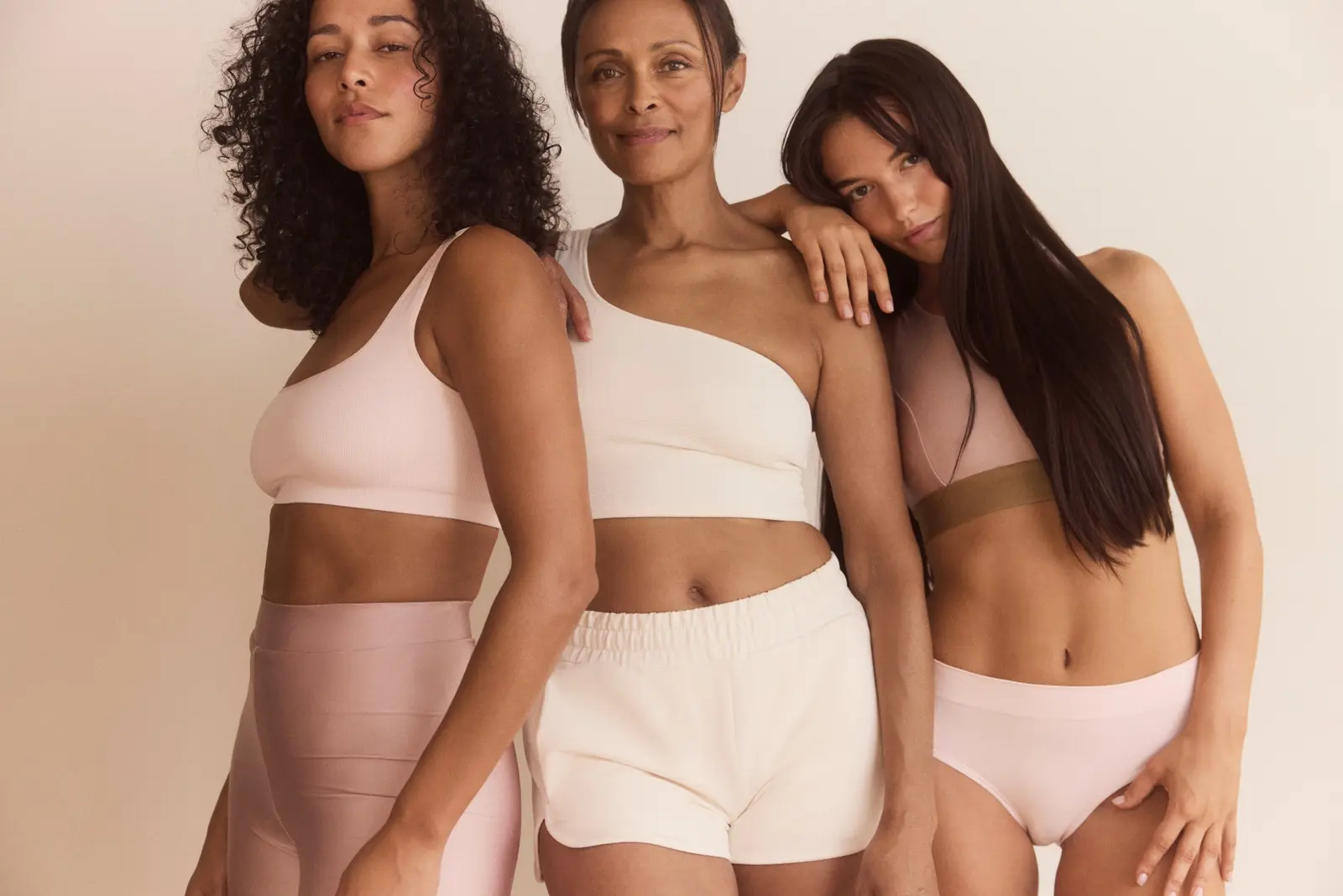 Three confident women in neutral activewear
